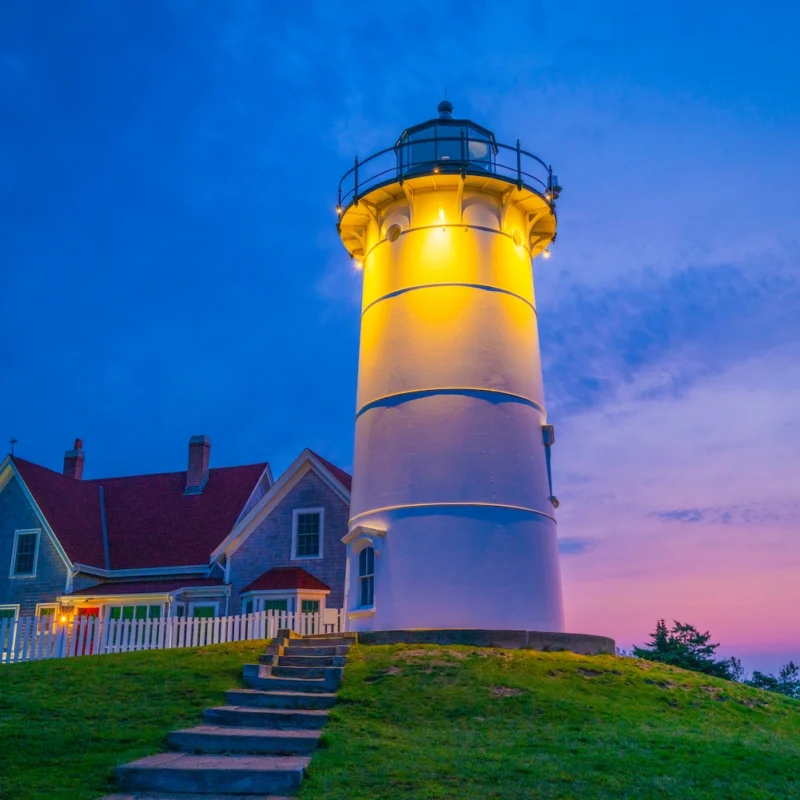 lighthouse lights on building in front of nice evening sky